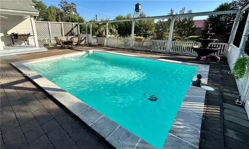 Imagine stepping into your backyard and being greeted by a stunning, newly renovated rectangular inground pool. Its pristine white color immediately catches your eye, giving it a modern and on-trend appearance. The pool's design is clean and sophisticated, enhancing the overall aesthetic of your outdoor space.