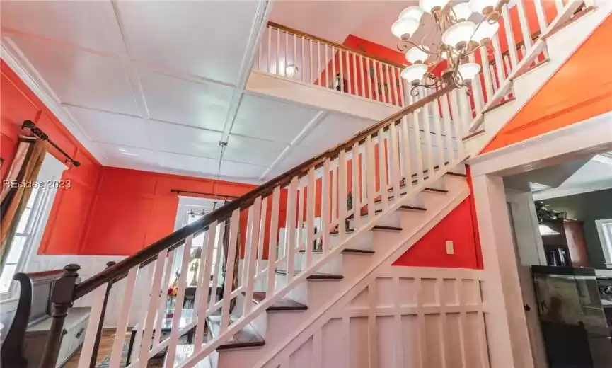 As you ascend the staircase to the second floor of this charming home, you'll find yourself in a welcoming space that leads to the guest bedrooms, a full bath, and a generous loft-style walkway. The staircase itself is well-crafted, providing a sense of elegance and practicality.