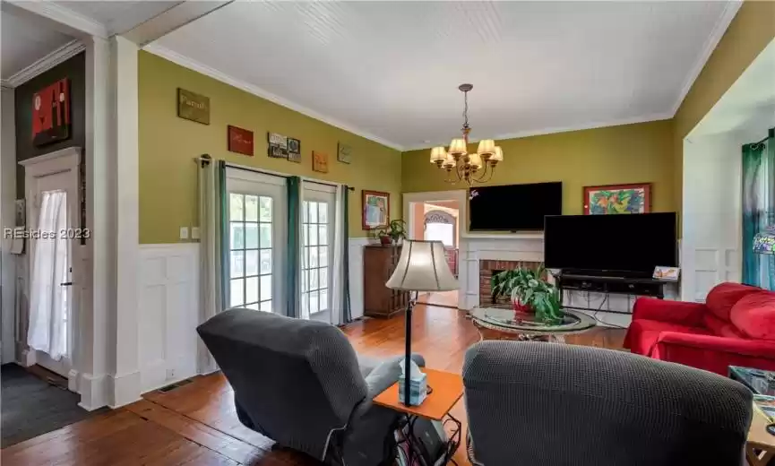 The living room offers room for entertaining and opens to the back porch proving great views of the newly renovated pool.