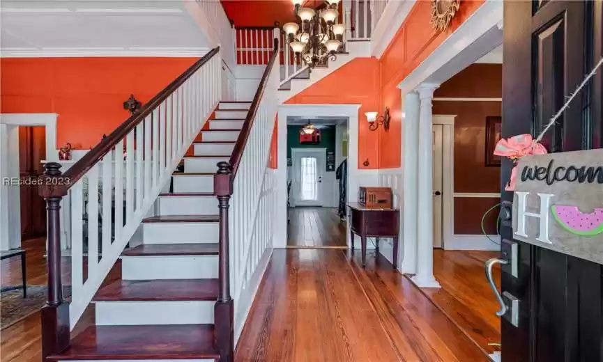 As you step inside, you're greeted by a welcoming foyer with a grand staircase that immediately catches your eye. The staircase adds an elegant touch to the entrance, giving the home a classic and timeless feel.