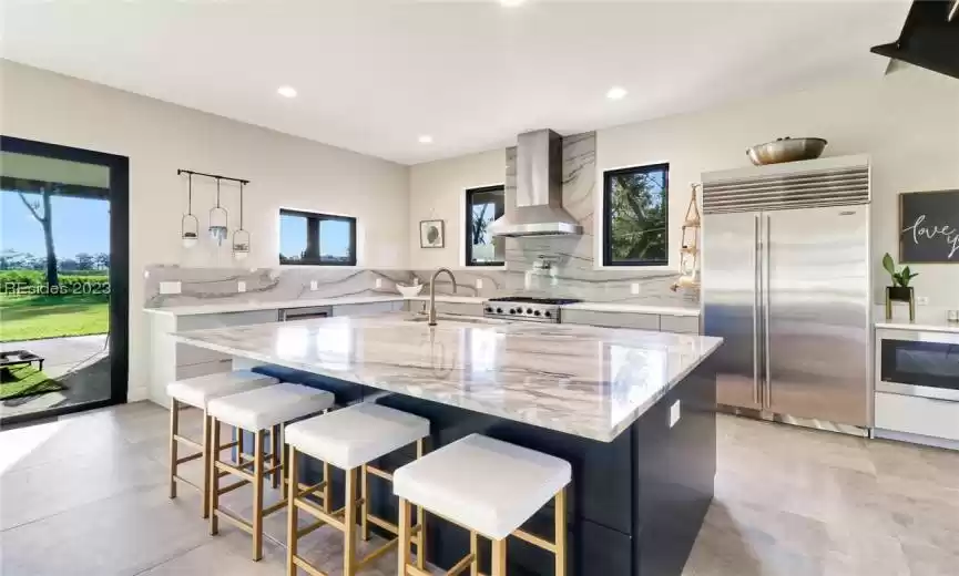 THE PANTRY IS JUST AS IMPRESSIVE AS THE KITCHEN WITH CUSTOM SHELVING AND STORAGE, AND ADDITIONAL FRIDGE.