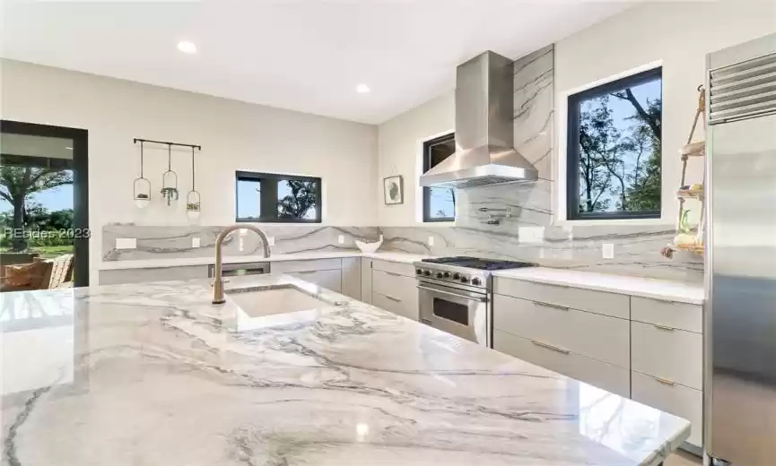 CUSTOM CABINETRY W/ VIKING RANGE, SUBZERO FRIDGE, QUARTZ COUNTERTOPS AND IMPRESSIVE SMART HOME BRIZO PLUMBING FIXTURES.