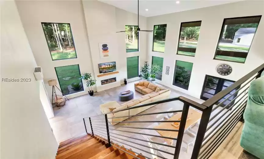 LOOK AT THIS BEAUTIFUL WORK OF ART STAIRCASE. IRON RAILING AND SOLID WOOD SLAB TREADS. JUST OUTSIDE THE ANDERSON WINDOWS COULD BE YOUR HORSES AND CHICKENS ROAMING.