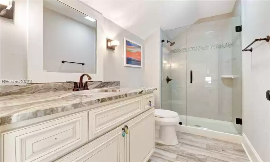Guest bath with granite counters and a large walk-in shower.