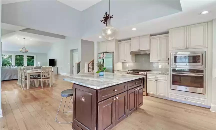 Kitchen features include high ceiling, granite counters and stainless appliances.