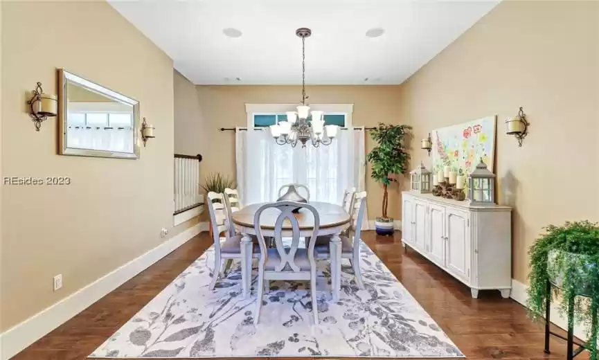 Large dining room with engineered wood flooring.