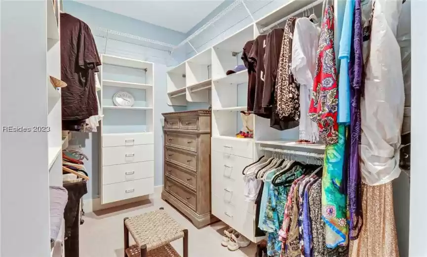 Spacious closet for master with built in cabinetry.