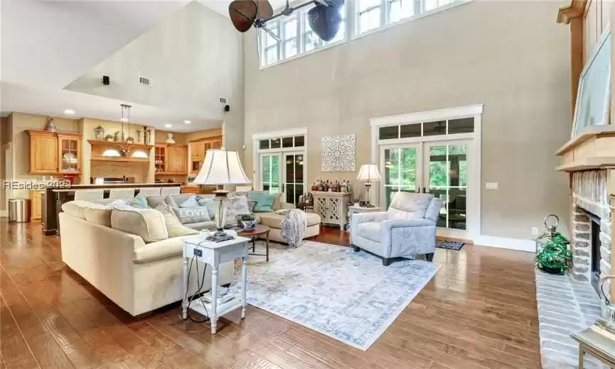 Great room with double french doors leads out to screened back porch.