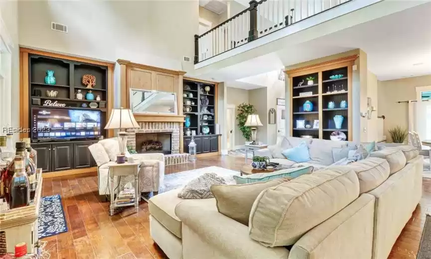 Great room with gas fireplace and builtin bookshelves.