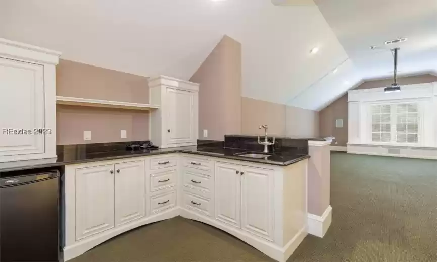 Upstairs home theatre room with private full bath on the left side of the home.