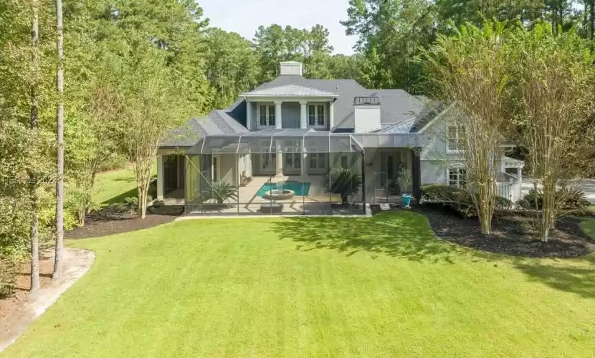 Spacious open backyard adjacent to a large lagoon perfect for some fishing.