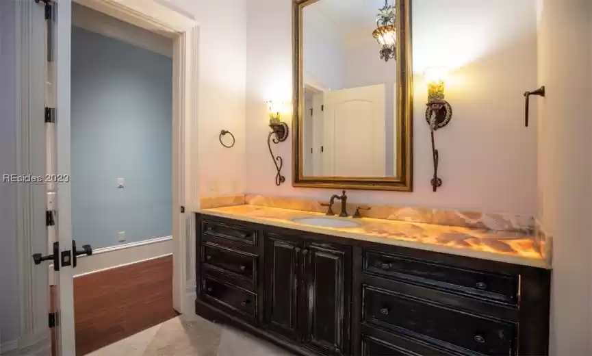 Lighted alabaster countertops in the primary bathrooms.