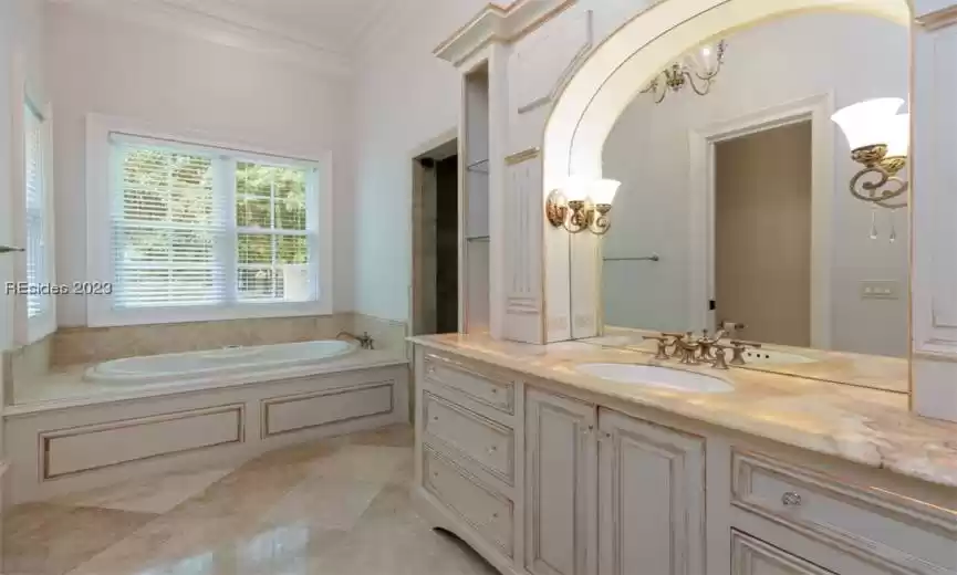 Lighted alabaster countertops in the primary bathrooms.