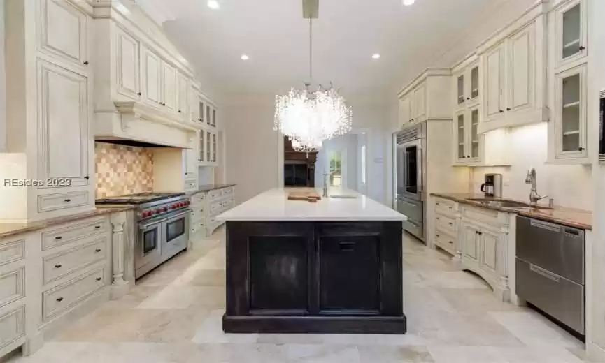 Kitchen with new quartz countertop island and gorgeous John-Richard chandelier.