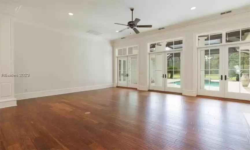 Main living area with three doors leading to outdoor pool, spa, kitchen and firepit.