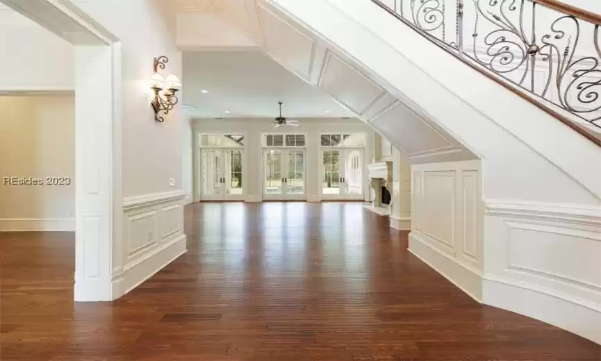 Beautiful entrance opening up to the dining room, living room and showcasing the custom ironwork staircase leading upstairs.