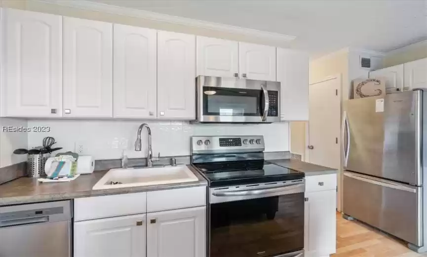 I love the white bright kitchen along with stainless steel appliances!