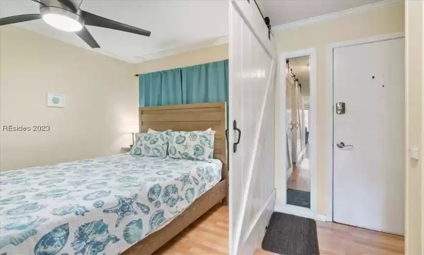 I love that the owners created a true bedroom with custom barn doors!