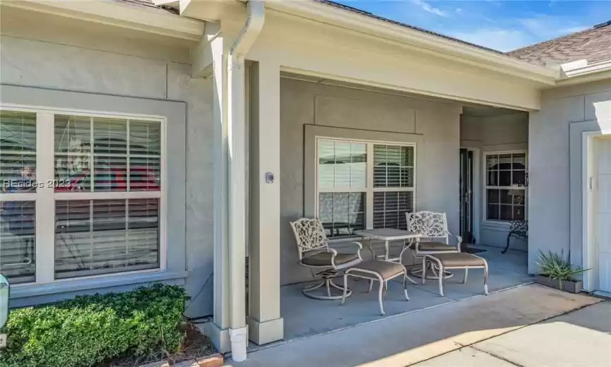 An attractive entryway features a front porch and sitting area.