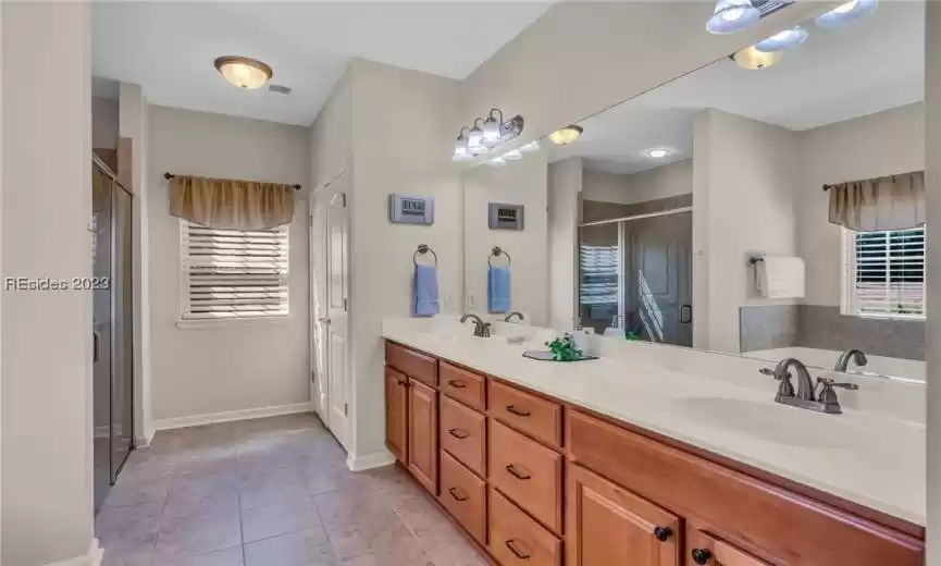 The gracious master bath has attractive tile, double vanities and well-positioned windows to let in the natural light.