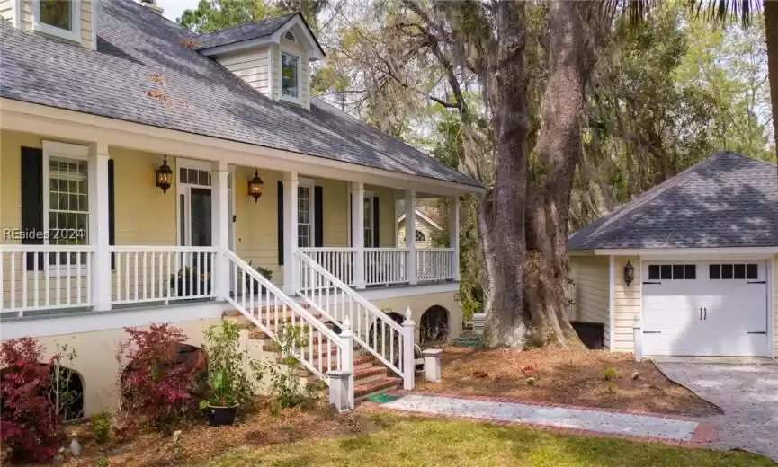 View of front facade with a porch and a garage