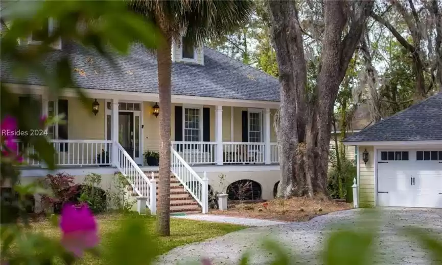 View of front of house with a garage and covered porch