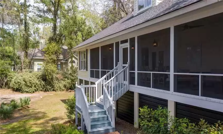 View of side of property with a sunroom