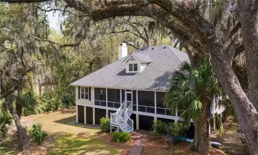 View of front of home featuring a sunroom