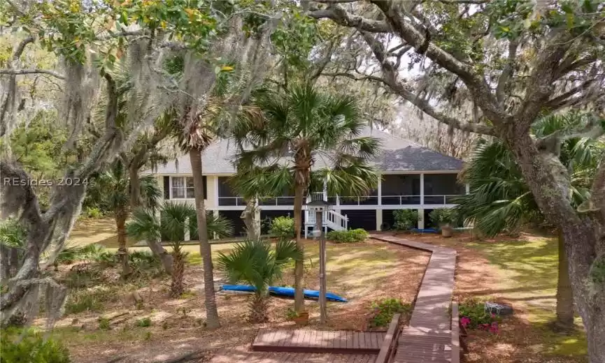 Back of property with a sunroom and a yard