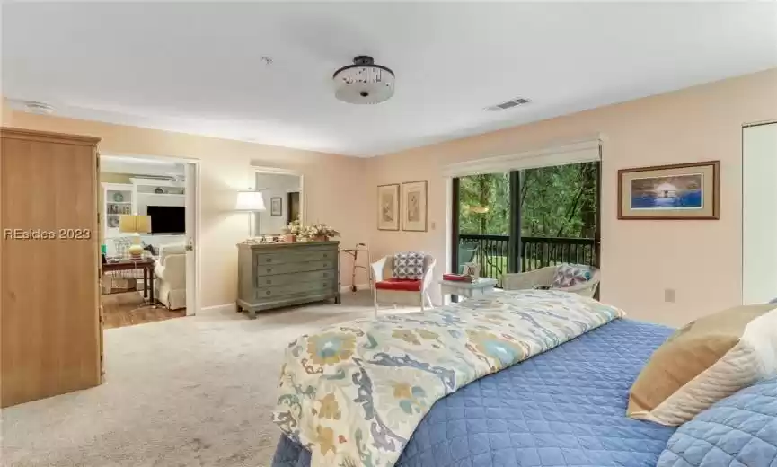 Carpeted bedroom with access to exterior