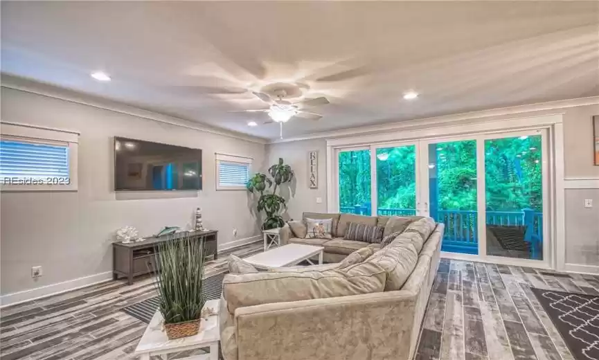 Living room featuring ceiling fan, plenty of natural light, and hardwood / wood-style floors
