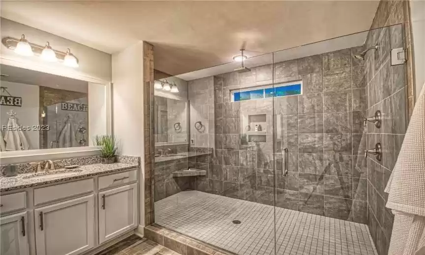 Bathroom with vanity and a shower with shower door