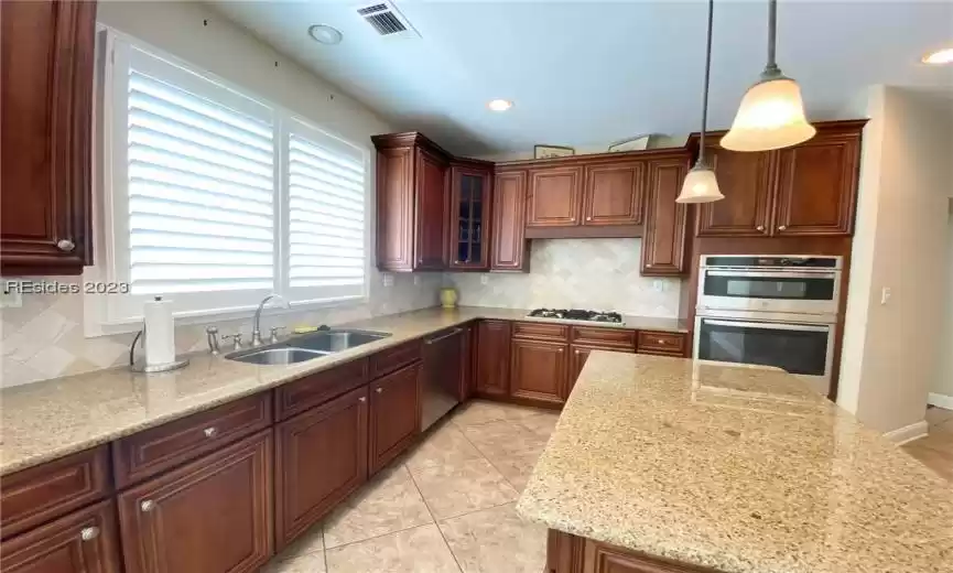Kitchen with new microwave and wall oven.