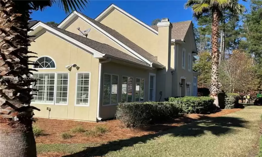 Back right corner view of home showcasing sunroom