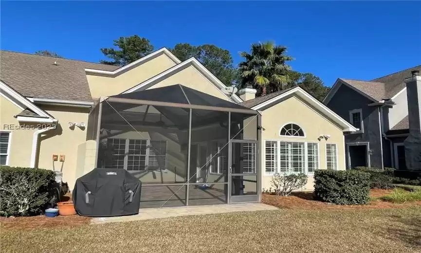 Back view of Home showcasing screen in porch and sunroom to the right