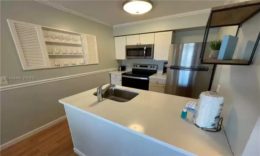 Full Kitchen featuring stainless appliances, quartz countertop and white cabinets.