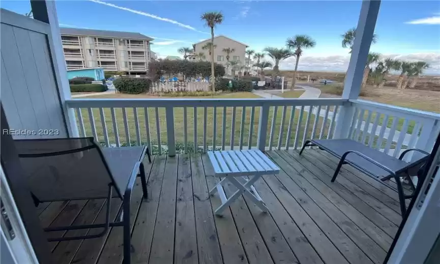 Large balcony from bedroom looking out to Cedar Reef Pool and ocean.