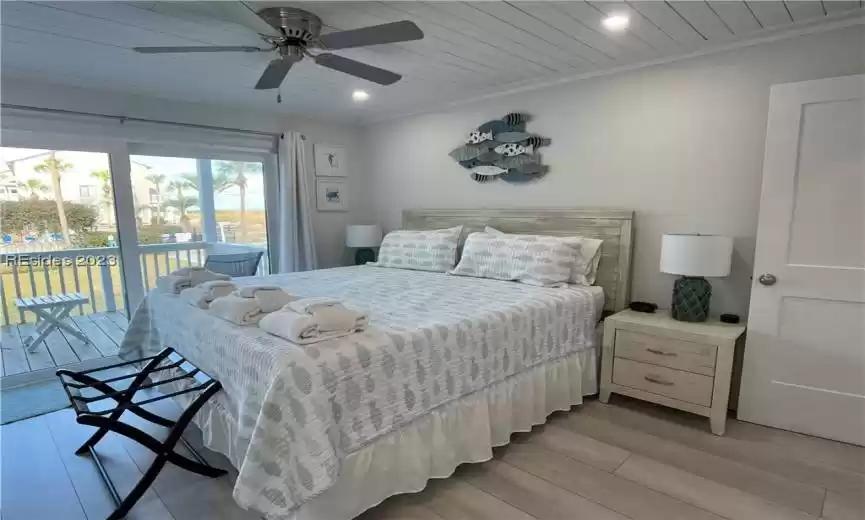 Beautifully decorated bedroom with shiplap ceiling throughout condo.