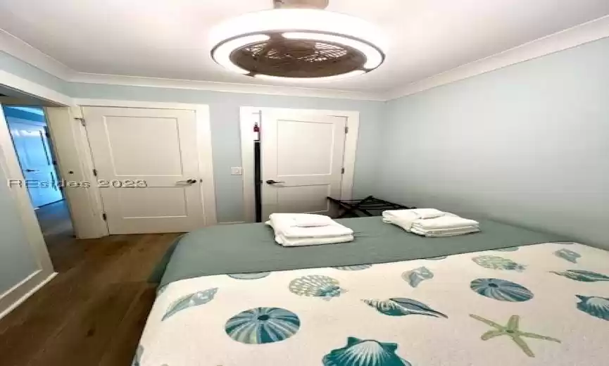 Bedroom featuring dark hardwood / wood-style floors and crown molding