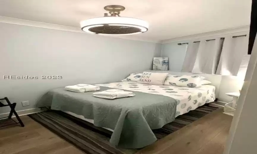 Bedroom featuring dark wood-type flooring and ornamental molding