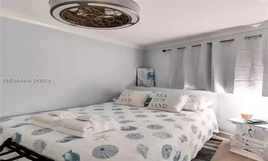 Bedroom featuring wood-type flooring Cottage moulding, Trim, Doors and Crown