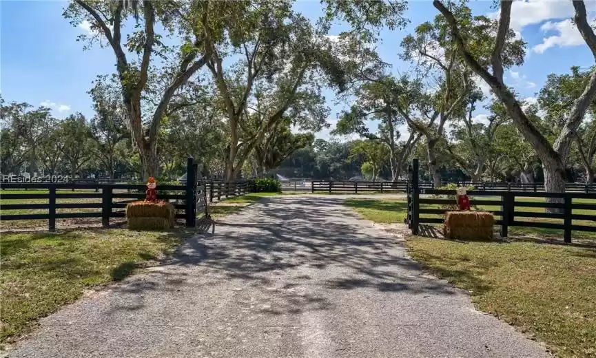 View of gate with a rural view and a yard