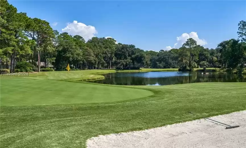 Surrounding community featuring a water view and a yard