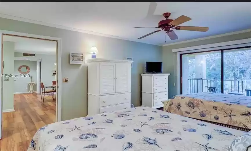 Two Queen Bedroom Suite featuring access to balcony, ceiling fan, light wood-type flooring, and crown molding