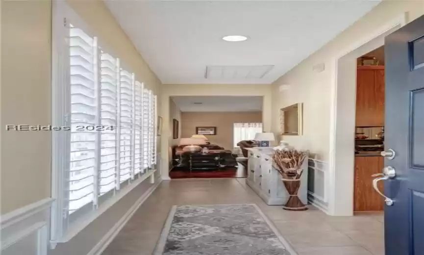 Hall featuring light tile floors