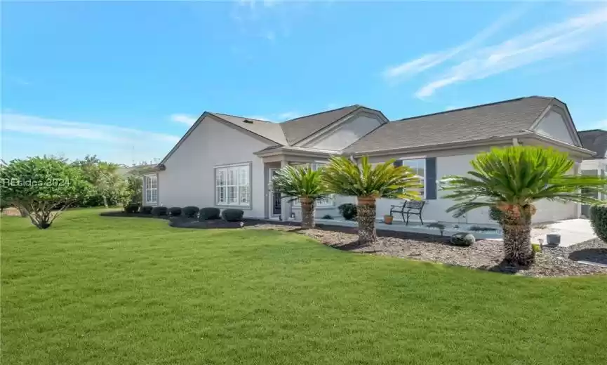 Rear view of house featuring a lawn