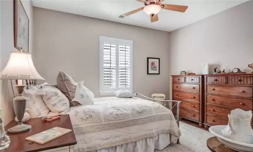 Bedroom featuring ceiling fan and a textured ceiling