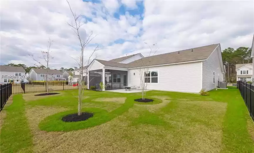 Rear view of property with a lawn