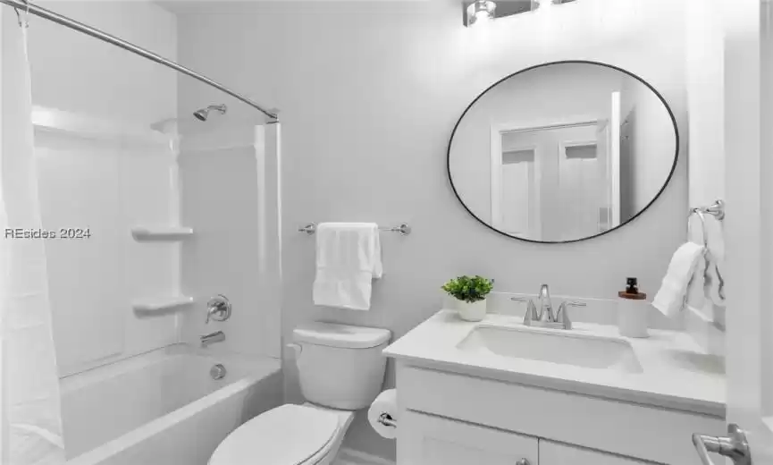 Full bathroom featuring washtub / shower combination, large vanity, and toilet