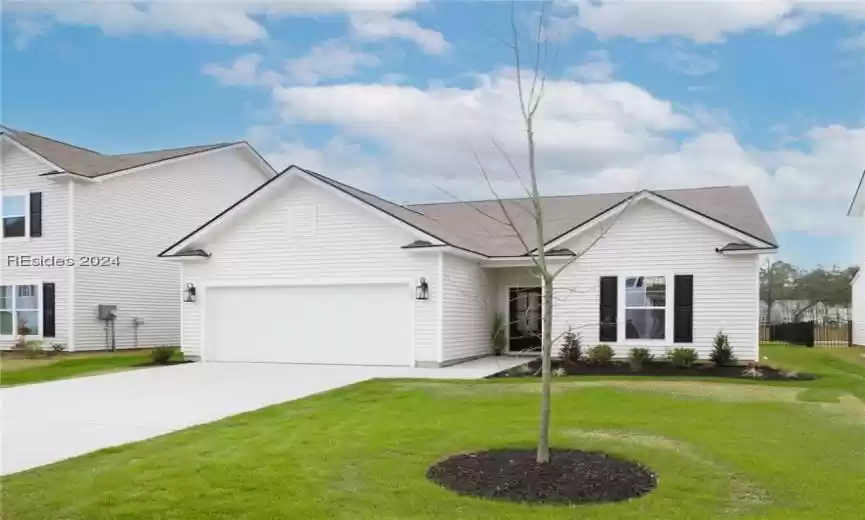 View of front of home featuring a front yard and a 2 car garage